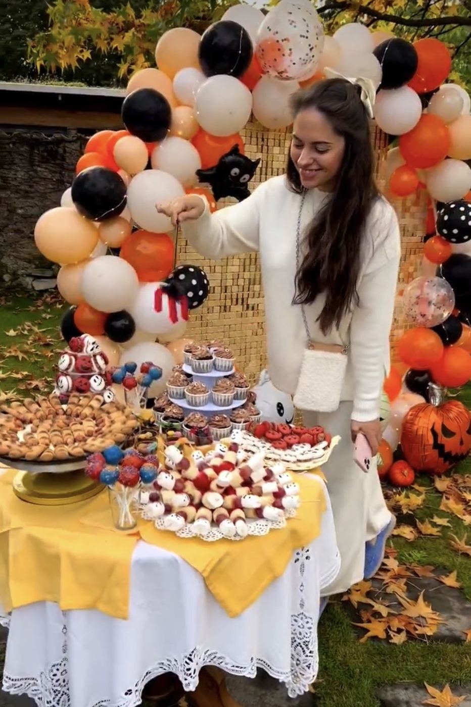 Halloween themed dessert table and balloon arch
