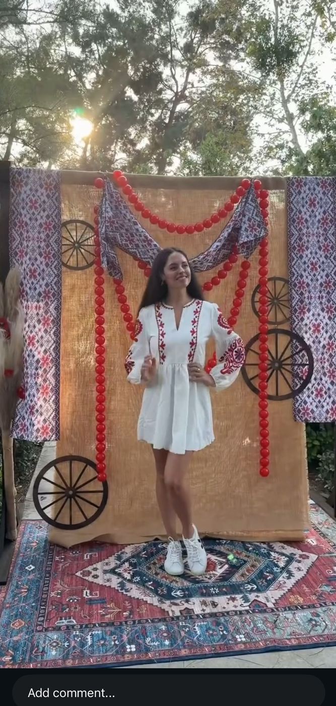 Ukrainian-themed photo backdrop with red garlands